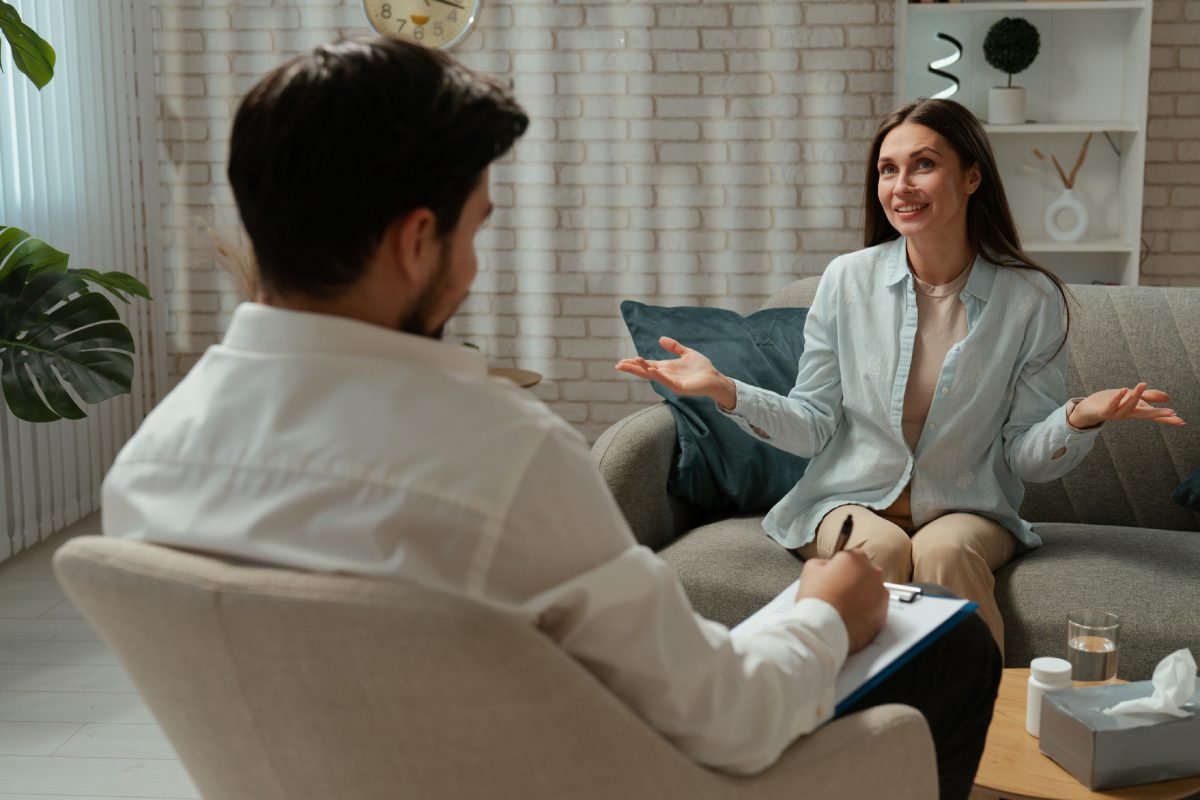 Woman talking to therapist in cozy office.