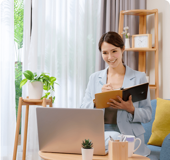 Woman working on laptop in home office.