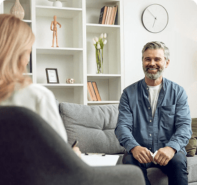 Man smiling during a therapy session.