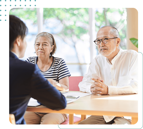 Elderly couple meeting with financial advisor.
