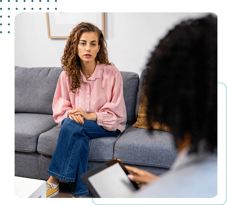 Woman talking to therapist on a sofa.