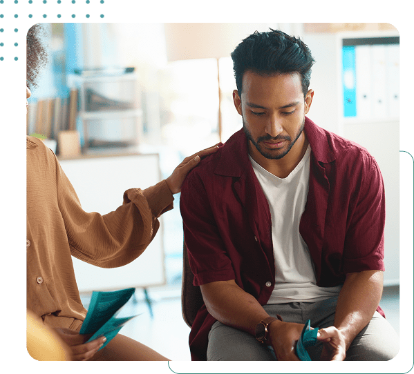 Person comforting another with supportive gesture.