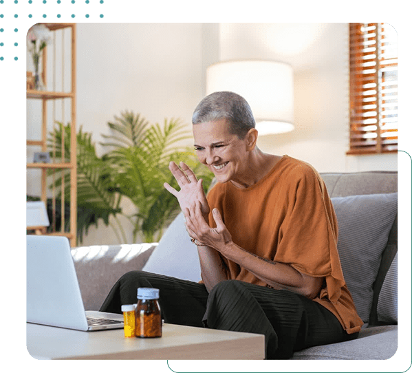 Smiling woman video calling on laptop.