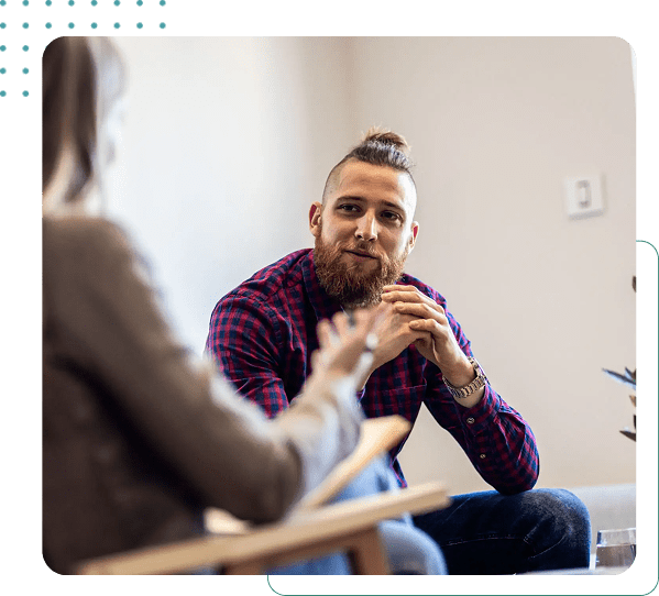 Man and woman having a conversation indoors.