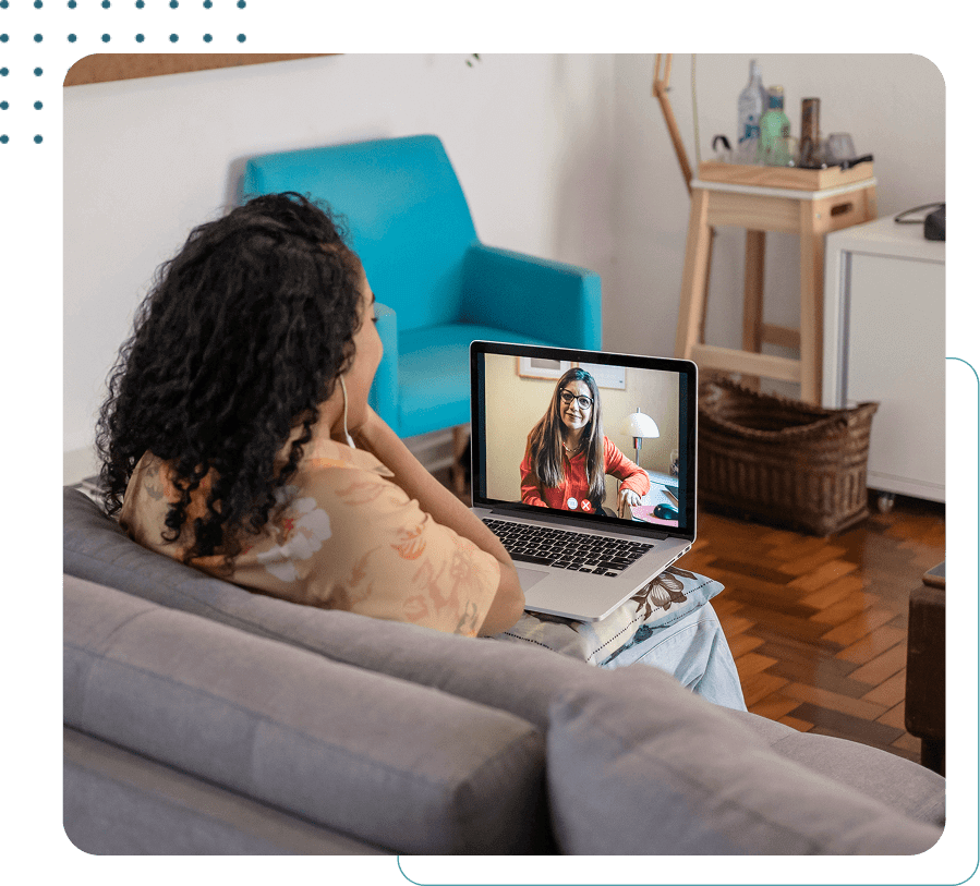 Woman video chatting on a laptop.
