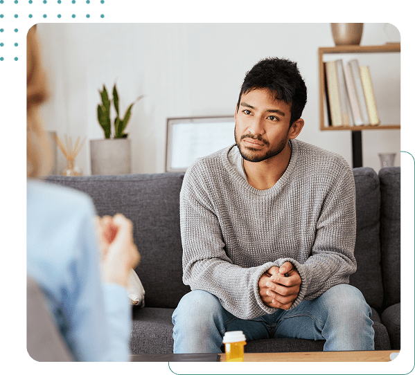 Man in therapy session on a couch.