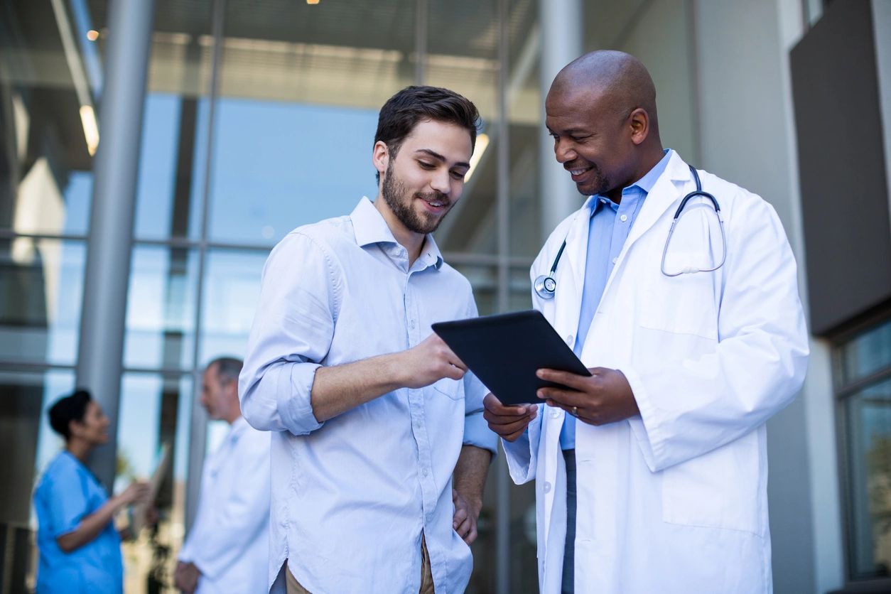 Doctor and patient discussing over a tablet.