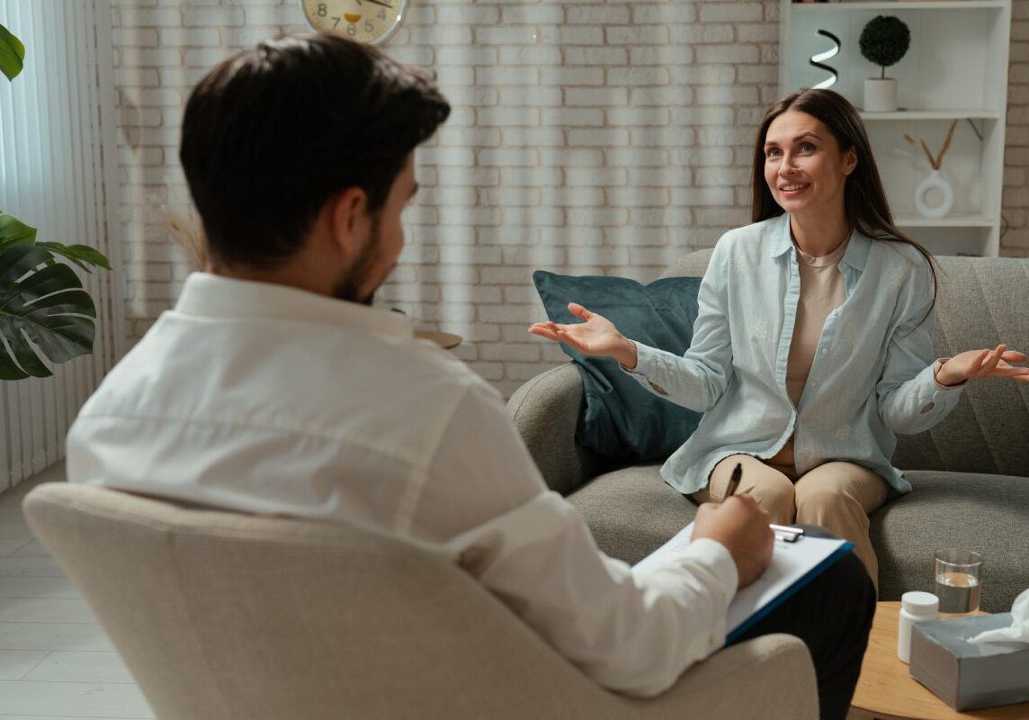 Woman talking to therapist in cozy office.
