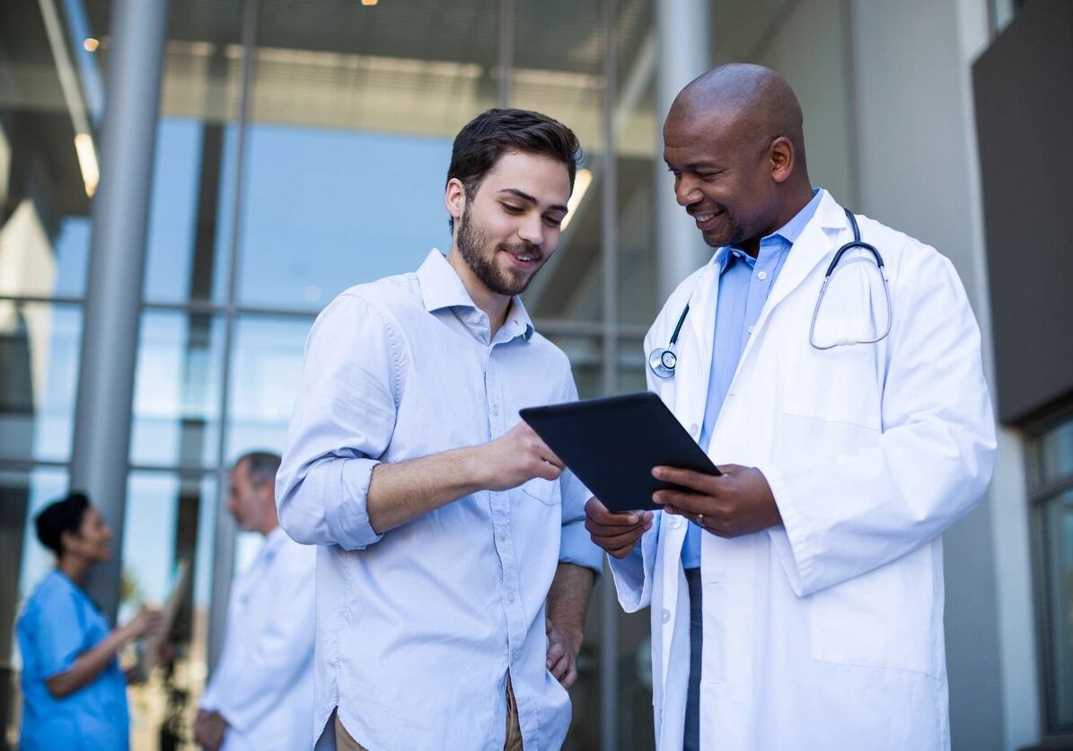 Doctor and patient discussing over a tablet.